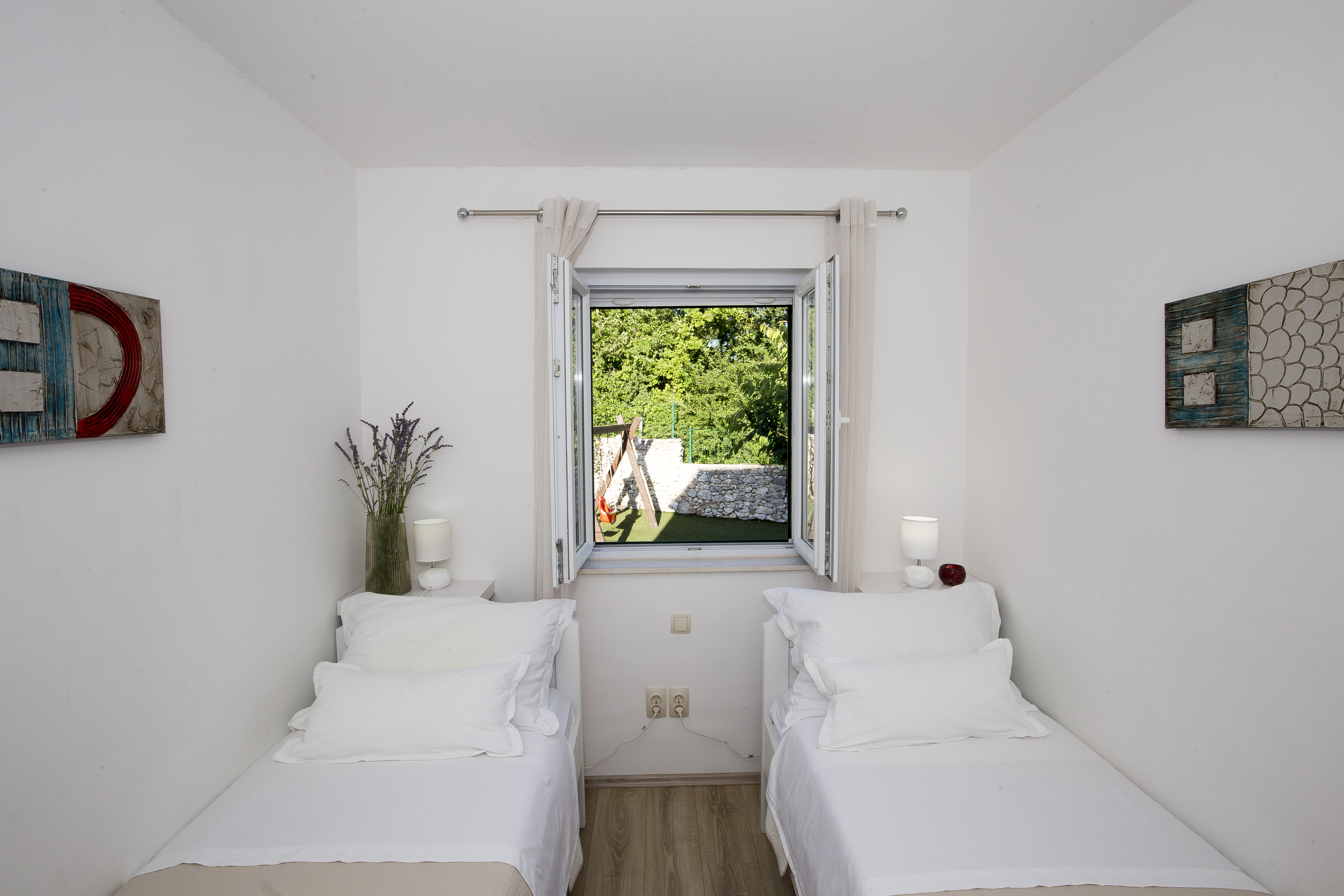 Bedroom 2 — twin beds with garden view