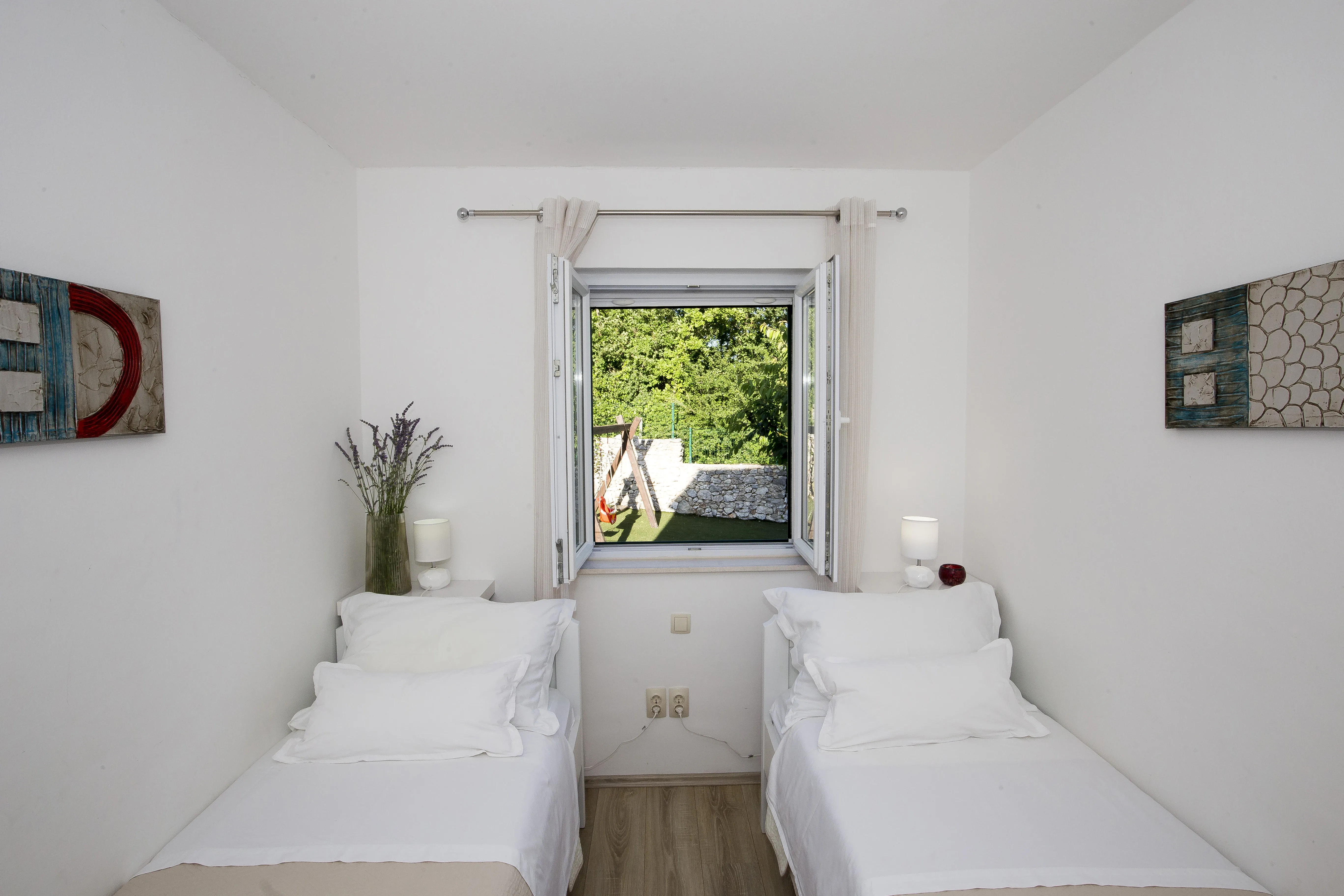 Bedroom 2 — twin beds with garden view